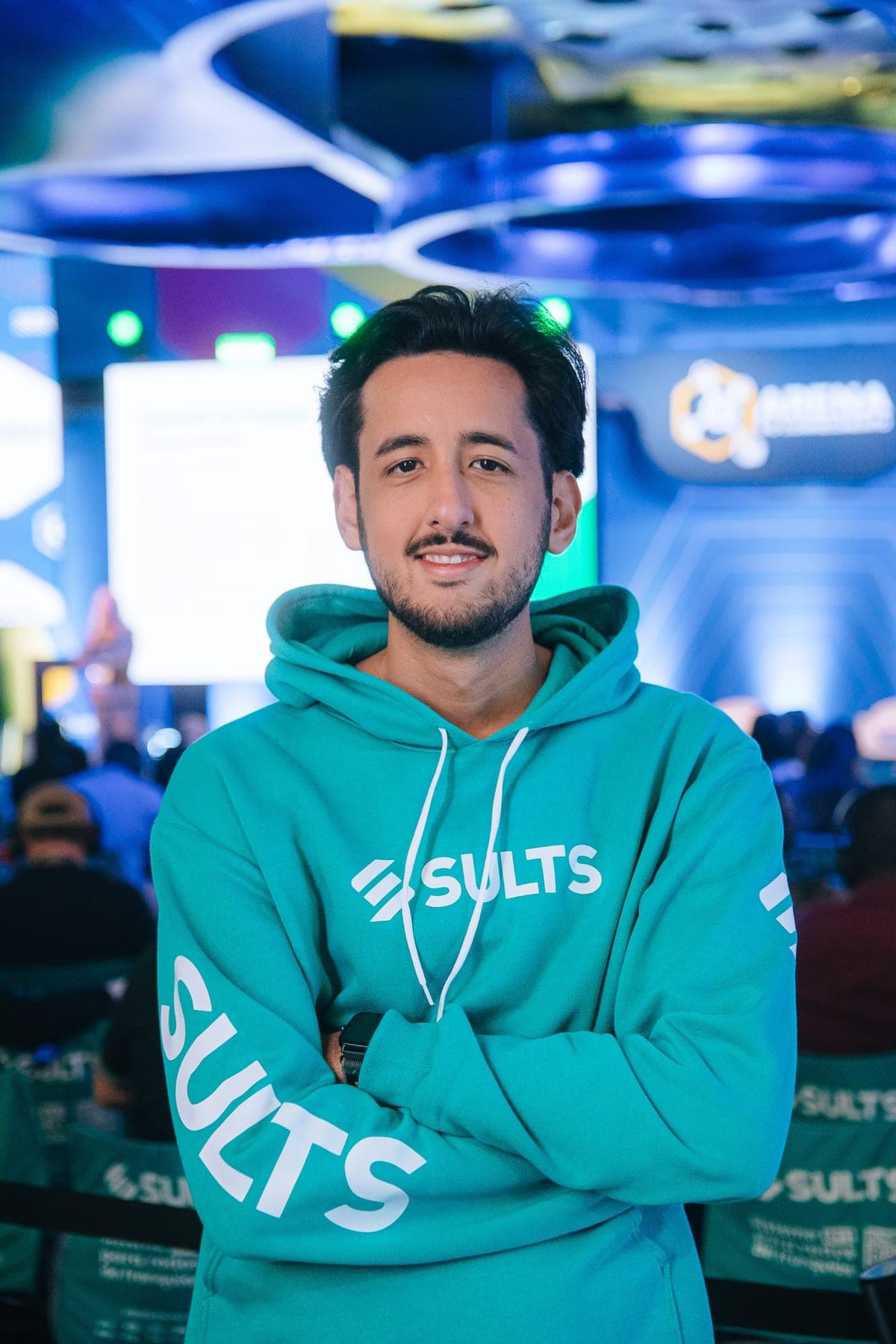 Eduardo wearing a SULTS hoodie at an event.